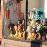 assorted color of doll in display cabinet