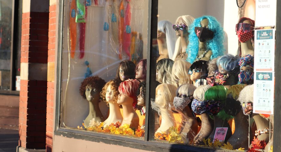 assorted color of doll in display cabinet