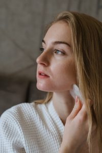 woman in white shirt mahing jawline