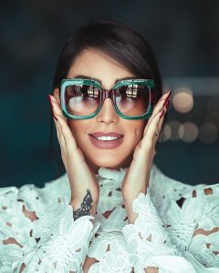 woman wearing green sunglasses